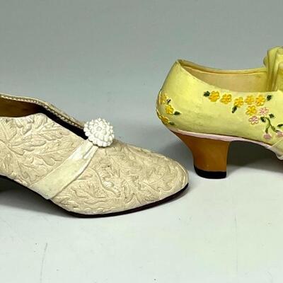 Lot of two white and yellow miniature shoe figurines