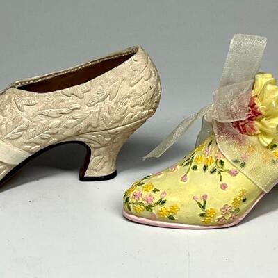 Lot of two white and yellow miniature shoe figurines