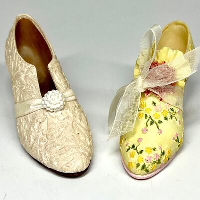 Lot of two white and yellow miniature shoe figurines