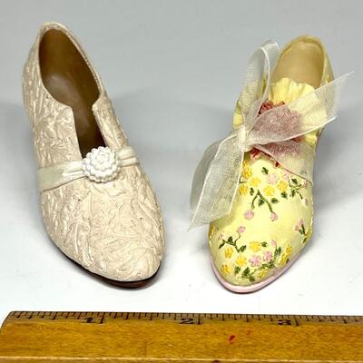Lot of two white and yellow miniature shoe figurines
