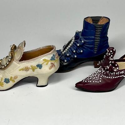 Lot of three white blue and purple miniature shoe figurines
