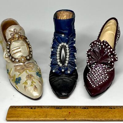Lot of three white blue and purple miniature shoe figurines
