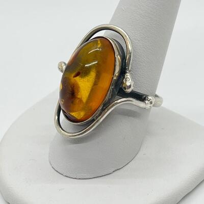 LOT 65: Sterling Silver and Amber Ring - Size 10