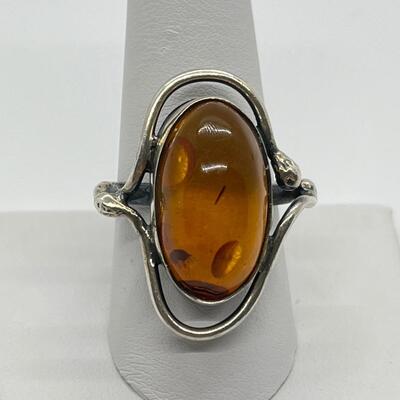 LOT 65: Sterling Silver and Amber Ring - Size 10