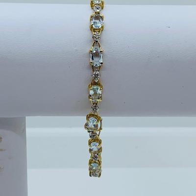 LOT 69: Light Blue Topaz & Diamond 14K Gold 7" Tennis Bracelet - 7.22 gtw