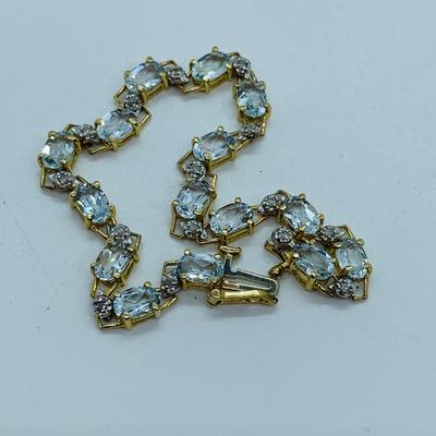 LOT 69: Light Blue Topaz & Diamond 14K Gold 7" Tennis Bracelet - 7.22 gtw