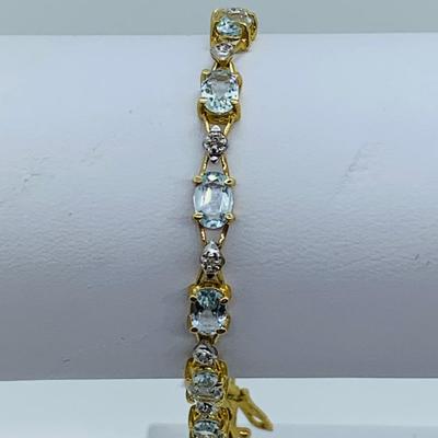 LOT 69: Light Blue Topaz & Diamond 14K Gold 7" Tennis Bracelet - 7.22 gtw