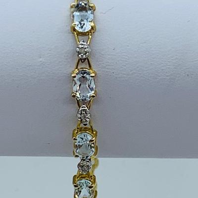 LOT 69: Light Blue Topaz & Diamond 14K Gold 7" Tennis Bracelet - 7.22 gtw