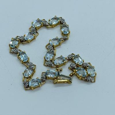 LOT 69: Light Blue Topaz & Diamond 14K Gold 7" Tennis Bracelet - 7.22 gtw