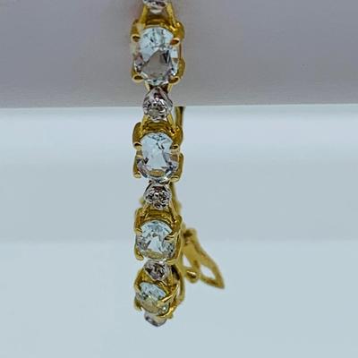 LOT 69: Light Blue Topaz & Diamond 14K Gold 7" Tennis Bracelet - 7.22 gtw