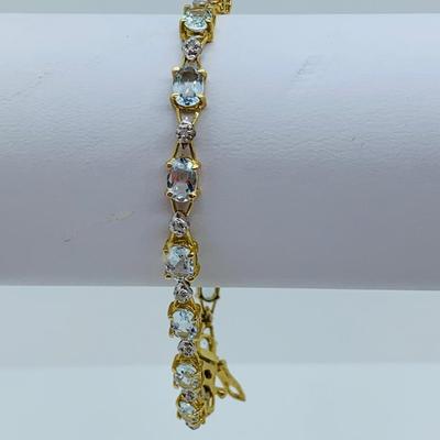 LOT 69: Light Blue Topaz & Diamond 14K Gold 7" Tennis Bracelet - 7.22 gtw
