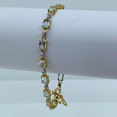 LOT 69: Light Blue Topaz & Diamond 14K Gold 7" Tennis Bracelet - 7.22 gtw