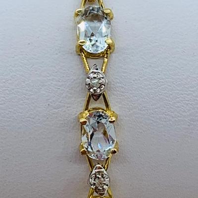 LOT 69: Light Blue Topaz & Diamond 14K Gold 7" Tennis Bracelet - 7.22 gtw