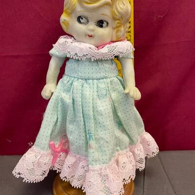 Porcelain doll and stand