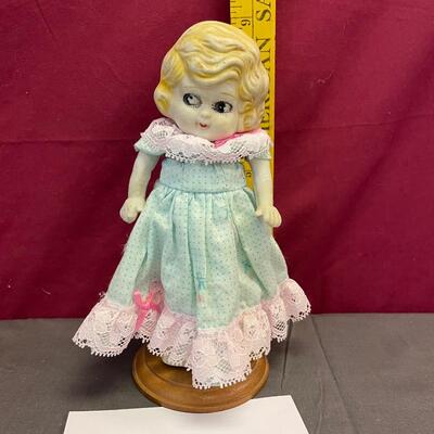 Porcelain doll and stand