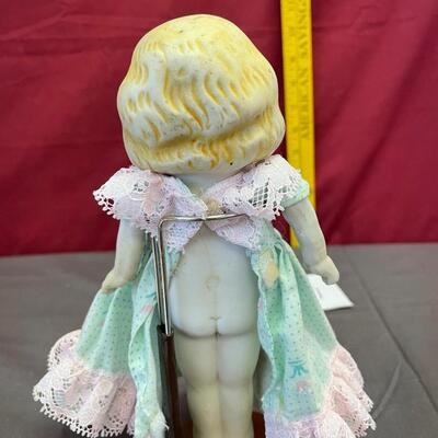 Porcelain doll and stand