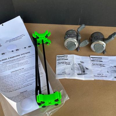 Lot 67. Two Synergy Reels and Rod/Reel Carrying System