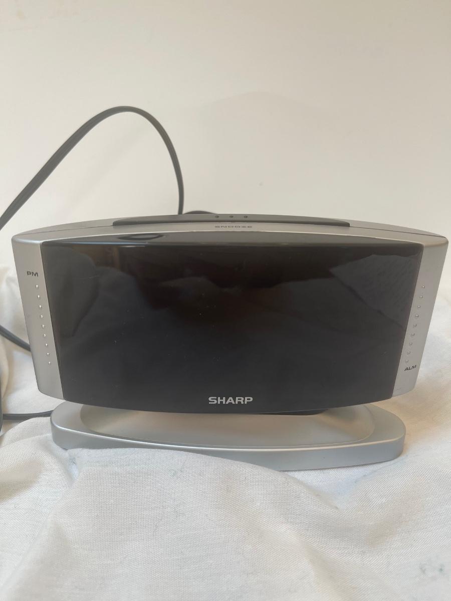 Sharp alarm clock. Model SPC033. Swivels. Use battery or electrical