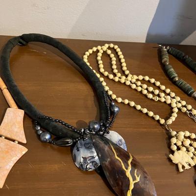 Nine piece necklace lot with shell, bone, wood and stone jewelry