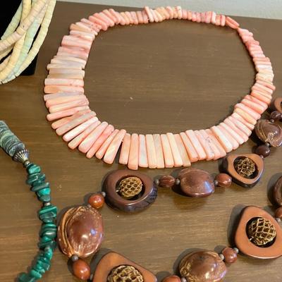 Nine piece necklace lot with shell, bone, wood and stone jewelry