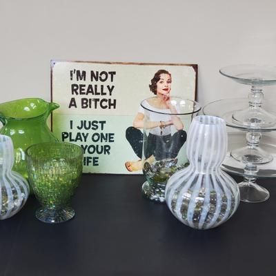 LOT 8G: Timeless Glassware:  Green Pitcher, Modern Vases, Pedestal Serving Plates, Tin Sign & More