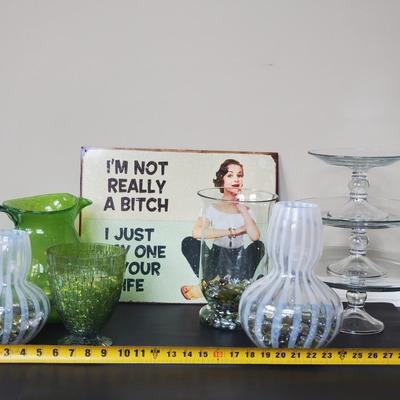LOT 8G: Timeless Glassware:  Green Pitcher, Modern Vases, Pedestal Serving Plates, Tin Sign & More