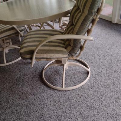Oval Metal Frame Patio Table with Four Swiveling Chairs