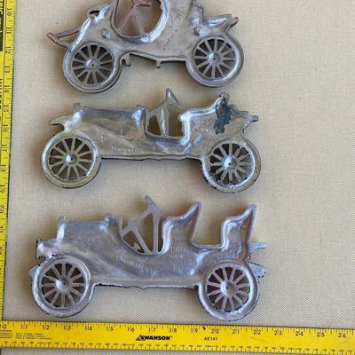 Three metal classic car wall hangings