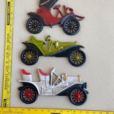 Three metal classic car wall hangings