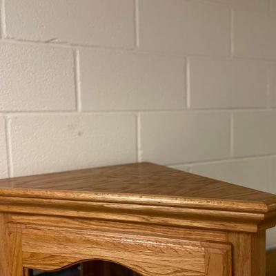 Corner cabinet with glass shelves and light