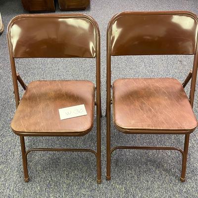 2 brown folding chairs