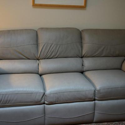 LEATHER SOFA IN SOFT GREY RECLINING ON BOTH ENDS. VERY GOOD CONDITION!