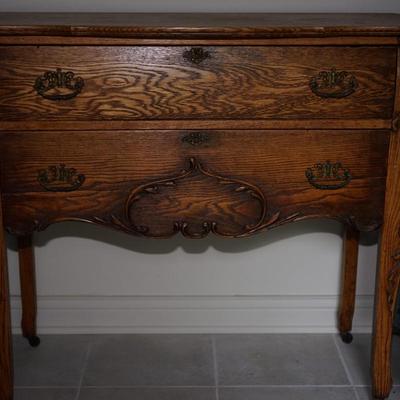 EARLY 1900'S TWO DRAWER BUREAU ON LEGS WITH APPLIED CARVING THROUGHOUT