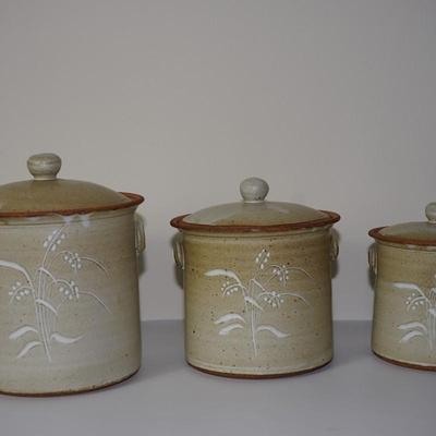 HAND CRAFTED CERAMIC POTTERY CANNISTER SET OF THREE. EMBOSSED WHEAT /APPLIED HANDLES