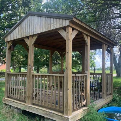 very nice treated wood Derkson gazebo w/ built in benches and metal roof.