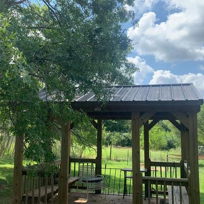 very nice treated wood Derkson gazebo w/ built in benches and metal roof.