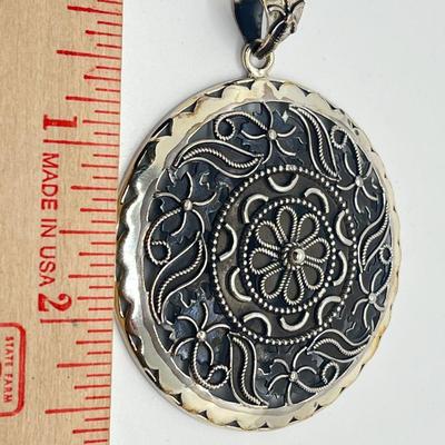 LOT 60: Artisan Crafted Sterling Silver Round Pendant