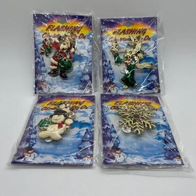 LOT 130: Four Sets Flashing Christmas Pins with Matching Earrings - Sealed, Untested