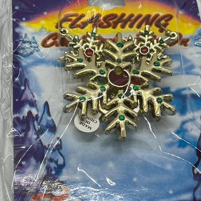 LOT 130: Four Sets Flashing Christmas Pins with Matching Earrings - Sealed, Untested