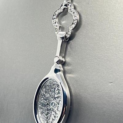 LOT 192: Silvertone Swivel Magnifying Pendant on 28" Chain
