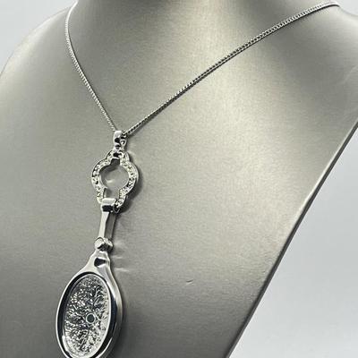 LOT 192: Silvertone Swivel Magnifying Pendant on 28" Chain