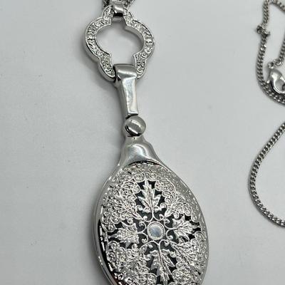LOT 192: Silvertone Swivel Magnifying Pendant on 28" Chain