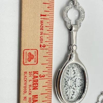 LOT 192: Silvertone Swivel Magnifying Pendant on 28" Chain