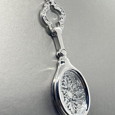 LOT 192: Silvertone Swivel Magnifying Pendant on 28" Chain