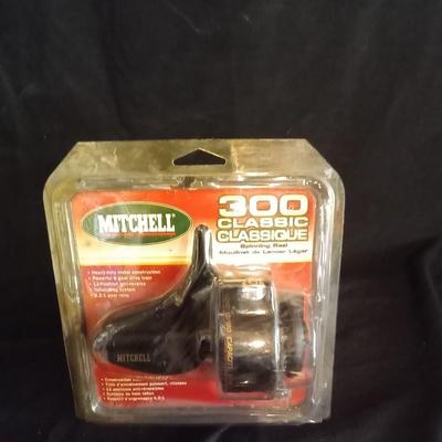 LOT 28 NEW MITCHELL FISHING REEL AND LURES