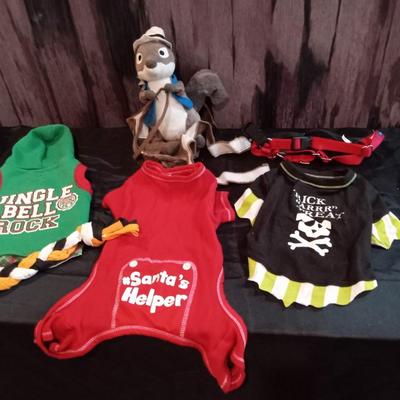 LOT 68  MEDIUM DOG CLOTHES, HARNESS AND A PLUSH SQUIRREL THAT RIDES ON YOUR DOGS BCK