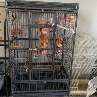 Very large vintage bird cage with lots of misc inside.