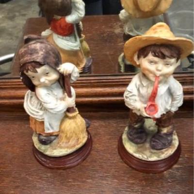 Two vintage boy and girl figurines