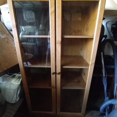 LOT 48 THREE SHELF WOODEN GLASS FRONT CABINET