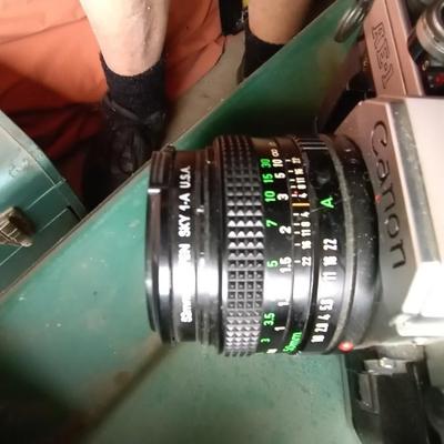 LOT 125 TWO CANON CAMERAS AND LENS